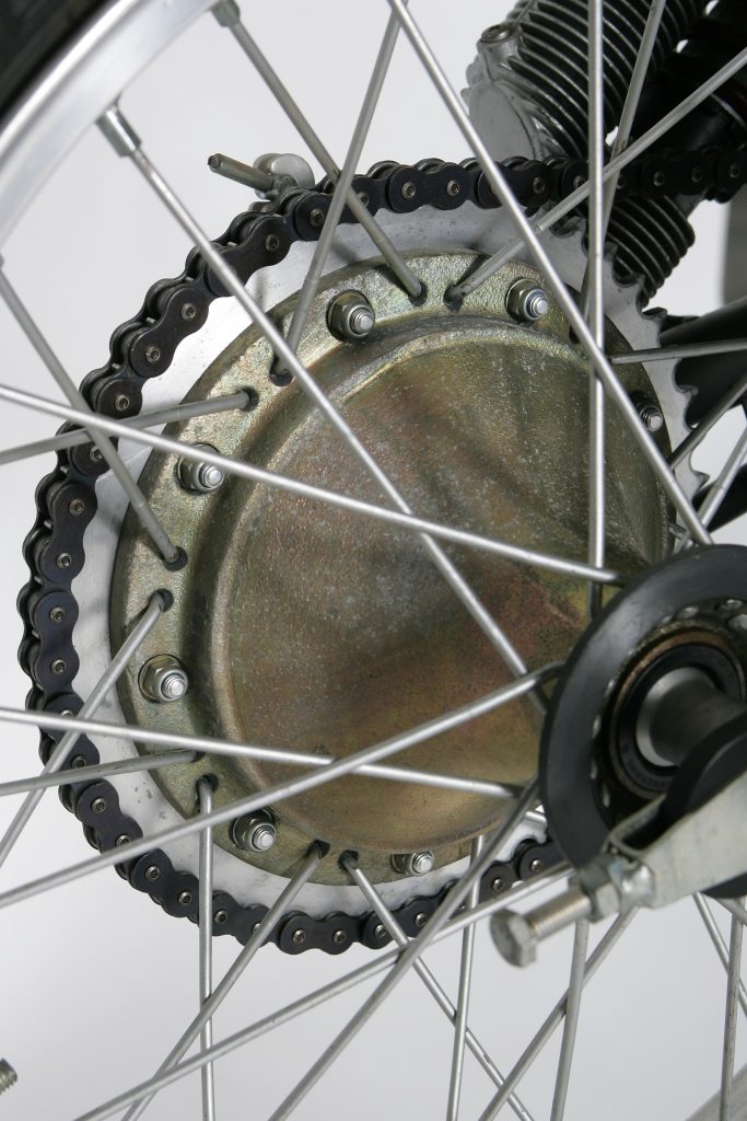 The front and rear hubs on the MC250 were sand-cast magnesium works parts to keep the weight as low as possible. About the