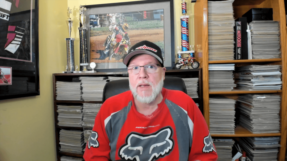 Tony Blazier in his office in front of shelves of classic motocross magazines